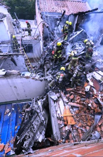 Firefighters work at the crash site.